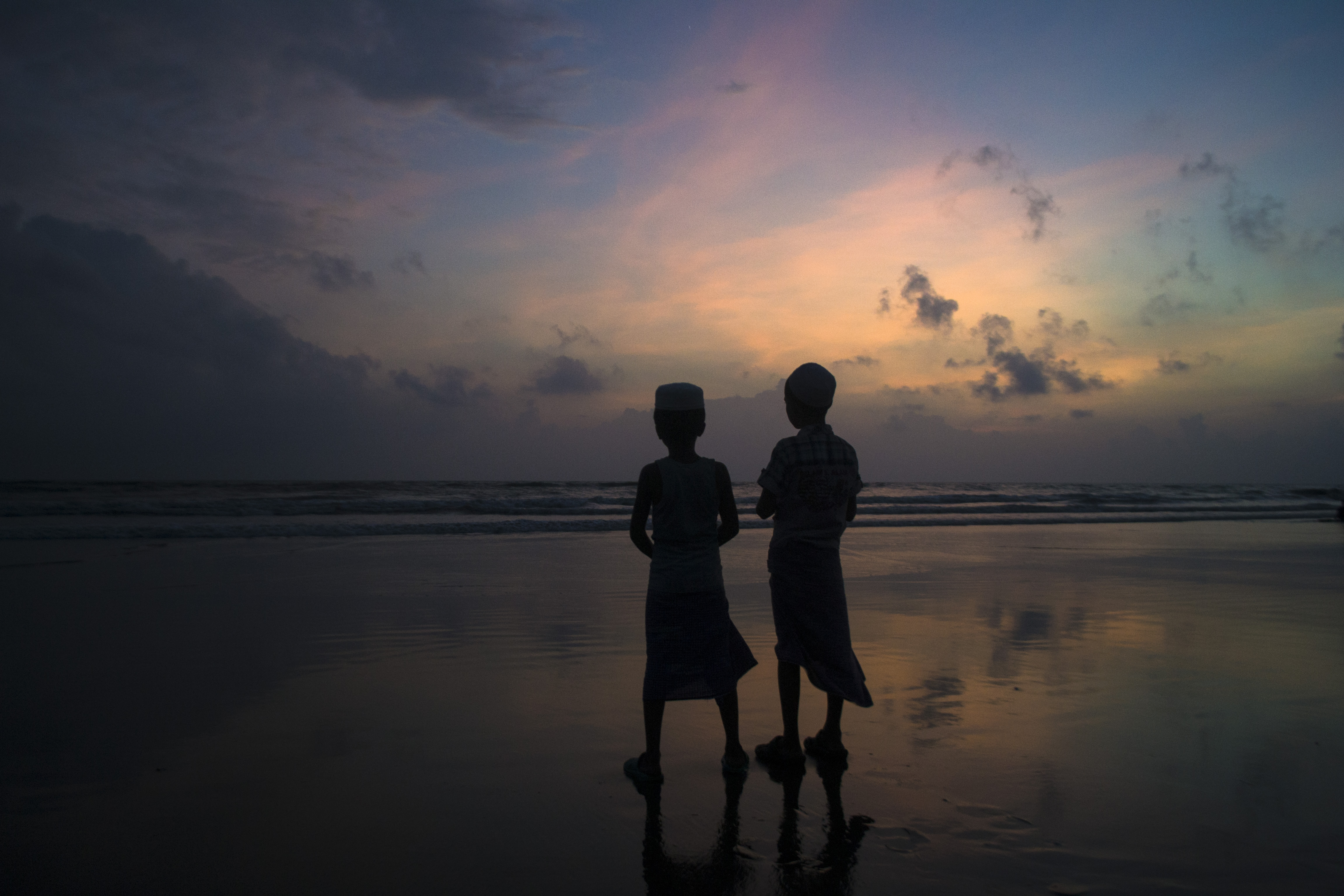 Two muslim kids at sunset